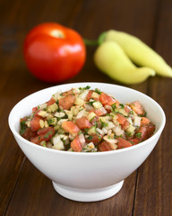 Poster - Chilean Pebre sauce, traditional condiment made of tomato, onion, garlic, spicy aji pepper and coriander, photographed with natural light (Selective Focus in middle of the pebre)