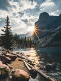 Fototapeta Fototapety góry  - Sunrise with turquoise waters of the Moraine lake with sin lit rocky mountains in Banff National Park of Canada in Valley of the ten peaks.