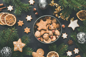 New Year or Christmas box with sweets Gingerbread cookies, gingerbread stars, dried orange rings and fir tree. Top view. Christmas flat lay composition