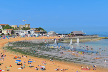 People enjoy the beach in Broadstairs, Kent as the hot weather in England continues. Beach goers swimming, sailing and sunbathing in the horseshoe Viking Bay in Kent county. England