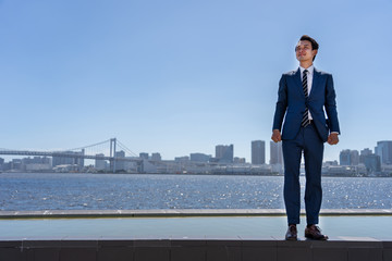 Wall Mural - portrait of asian businessman in blue sky