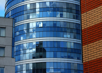 a glass office building between two other buildings