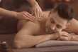 © Pixel-Shot - Young man receiving massage at spa salon