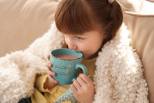 Cute Little Girl With Cup Of Hot Cocoa Drink At Home