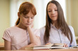 © Evgeny Sumin - 2 student girls are sitting at a Desk
