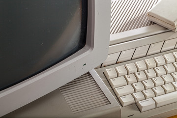 Old grubby outdated tech. Close-up of a vintage computer system. Retro technology equipment.