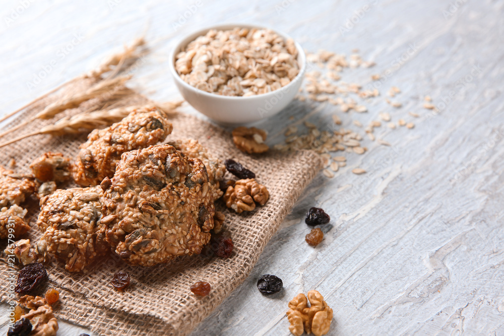 Delicious oatmeal cookies on textured background