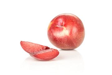 Group of one whole two slices of fresh pluot interspecific plums variety isolated on white