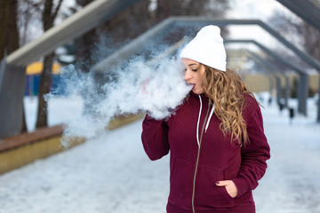 Young woman smoking electronic cigarette, young woman vaping. Vape