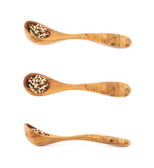 Wall Mural - Wooden spoon of quinoa seeds isolated