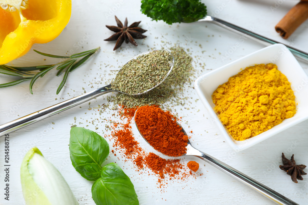 Various spices with herbs on wooden background