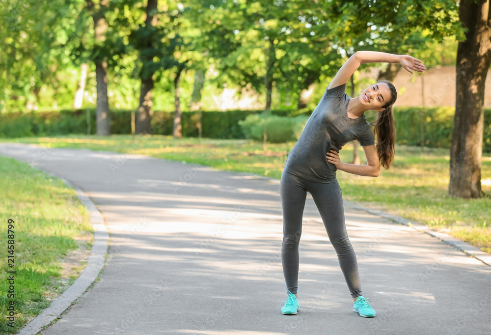 Sporty young woman training outdoors