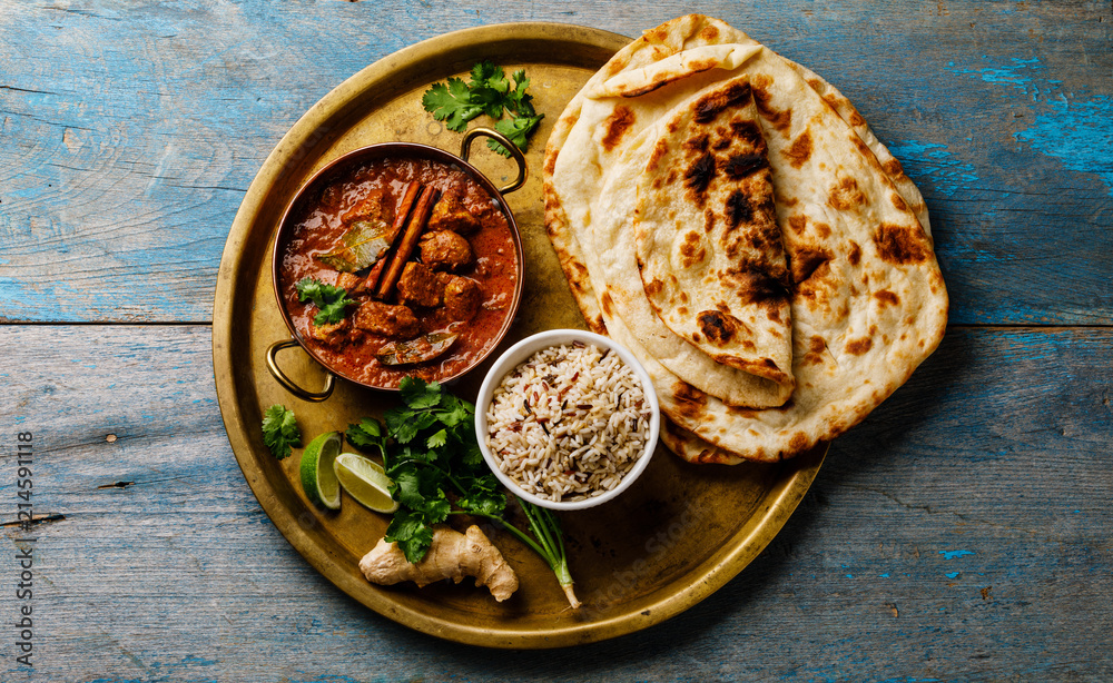 Chicken tikka masala spicy curry meat food with rice and naan bread on wooden background - obrazy, fototapety, plakaty 