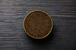 Black caviar in can on black wooden background