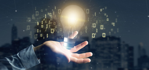 Poster - Businessman holding a bulb lamp idea concept with data all around 3d rendering