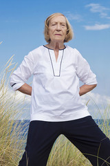 A senior woman practicing Tai Chi