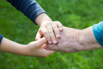 hand of a boy in the hand of a grandmother close-up