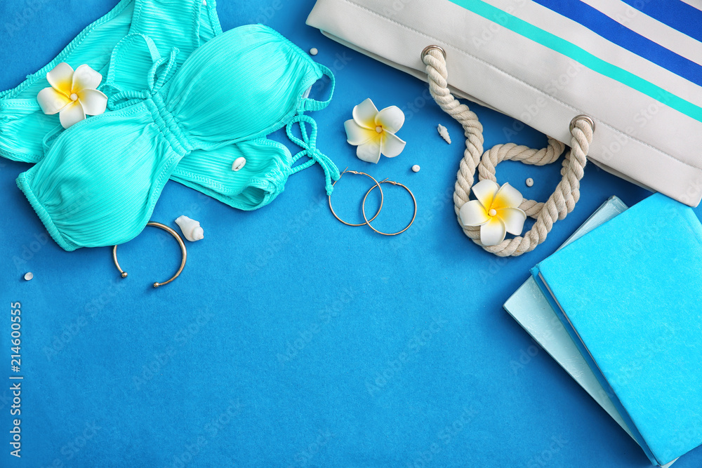 Composition with swimsuit, books and stylish accessories on color background