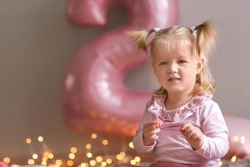 Wall Mural - Cute little girl on his second birthday at home