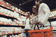 © VadimGuzhva - Close up. Family in Supermarket Buying Cookies.