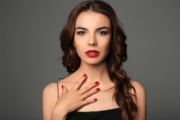 Poster - Young woman with beautiful manicure on grey background