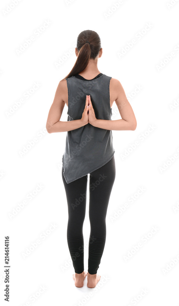 Young woman practicing yoga on white background