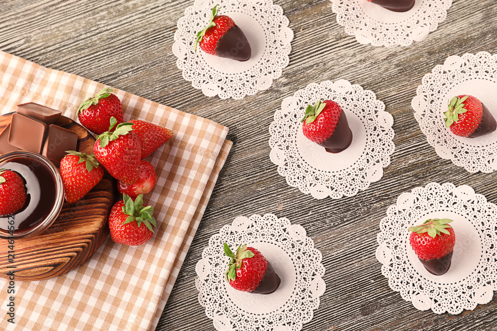 Delicious strawberries with chocolate on wooden table