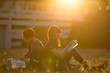 © torwaiphoto - Student was reading in the outdoors and good weather. And they're happy.lens flare