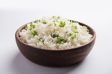 Wall Mural - Coriander or cilantro Basmati Rice, served in a ceramic or terracotta bowl. It's a popular Indian OR Chinese recipe. Selective focus