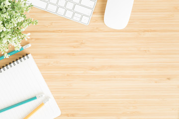 Wall Mural - flat lay photo of office desk with mouse and keyboard ,top view workpace on bamboo wood table and co