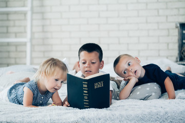 Sticker - children read a book on the bed