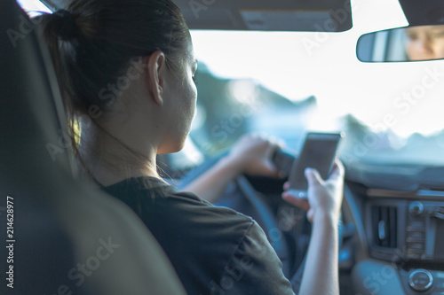 Fotografie, Obraz Driving and texting in car with blue tone
