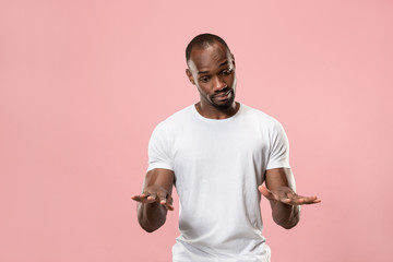 Wall Mural - Beautiful male half-length portrait isolated on pink studio backgroud. The young emotional surprised man