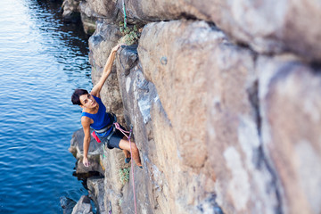 Wall Mural - girl climber climbs up.