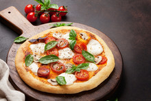 Italian Pizza With Tomatoes, Mozzarella And Basil