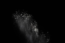 White Powder Explosion Isolated On Black Background.