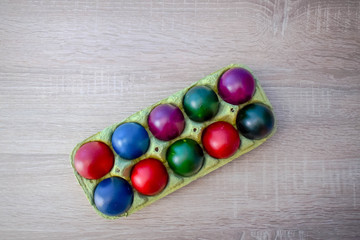 Wall Mural - Color Easter Eggs on Wooden Background