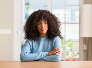 Poster - African american woman at home smiling looking side and staring away thinking.