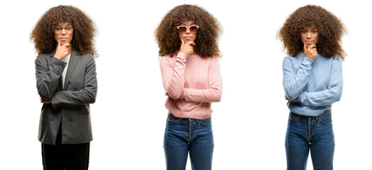 Poster - African american young woman wearing different outfits looking confident at the camera with smile with crossed arms and hand raised on chin. Thinking positive.