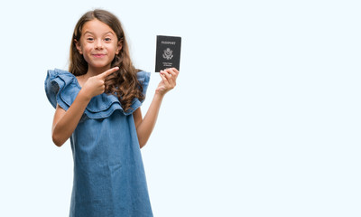 Poster - Brunette hispanic girl holding passport of United States of America very happy pointing with hand and finger