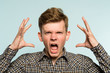 emotional breakdown. angry man in distress. agony and rage concept. portrait of a young guy on light background. emotion facial expression. feelings and people reaction.