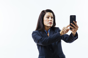 Wall Mural - Portrait of business woman pressing on her cell phone, isolated on white studio background