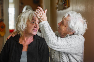 Poster - Portrait of an elderly woman with her adult daughter.