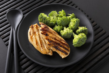 Food for health. Grilled turkey and broccoli. The concept of a healthy lifestyle. The background is black. Copy space.