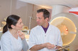 © auremar - male in 40s undergoing mri in hospital with doctor supervising