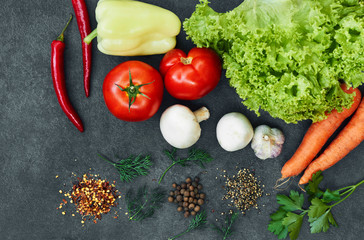 Healthy food background. Healthy food concept with fresh vegetables and ingredients for cooking. Top view with copy space. Aromatic herbs, onion, pepper, cucumber,lettuce, carrots, tomatoes