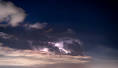 Fototapete - Thunder, lighting in the clouds at night sky above city