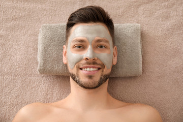 Wall Mural - Handsome man with cosmetic mask in spa salon