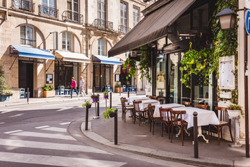 Wall Mural - cozy street with tables of cafe in paris, france