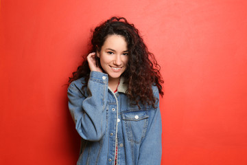 Young beautiful woman on color background